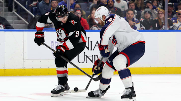 Apr 9, 2026; Buffalo, New York, USA;  Buffalo Sabres center Josh Norris (9) and Columbus Blue Jackets defenseman Erik Gudbranson (44) go after a loose puck during the second period at KeyBank Center. Mandatory Credit: Timothy T. Ludwig-Imagn Images