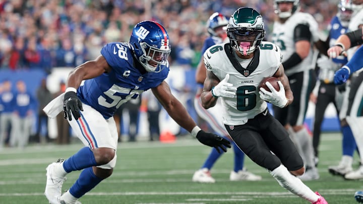 Oct 9, 2025; East Rutherford, New Jersey, USA; Philadelphia Eagles wide receiver DeVonta Smith (6) carries the ball defended by New York Giants linebacker Bobby Okereke (58) during the first quarter of the game at MetLife Stadium. Mandatory Credit: Vincent Carchietta-Imagn Images