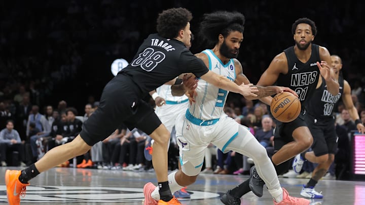 Mar 31, 2026; Brooklyn, New York, USA; Charlotte Hornets guard Coby White (3) brings the ball up court against Brooklyn Nets guard Nolan Traore (88) and forward Chaney Johnson (31) during the fourth quarter at Barclays Center. Mandatory Credit: Brad Penner-Imagn Images