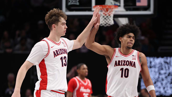Mar 14, 2026; Kansas City, MO, USA; Arizona Wildcats center Motiejus Krivas (13) and forward Koa Peat (10) high-five during the second half against the Houston Cougars during the men's Big 12 Conference Tournament Championship at T-Mobile Center. Mandatory Credit: William Purnell-Imagn Images Mar 14, 2026; Kansas City, MO, USA; Arizona Wildcats center Motiejus Krivas (13) and forward Koa Peat (10) high-five during the second half against the Houston Cougars during the men's Big 12 Conference Tournament Championship at T-Mobile Center. Mandatory Credit: William Purnell-Imagn Images