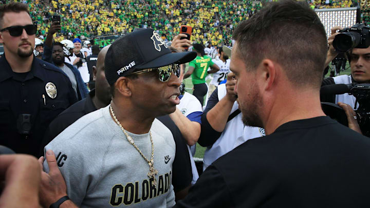 Colorado coach Deion Sanders, left, and Oregon's Dan Lanning meet at midfield after the game in Eugene Saturday, Sept. 23, 2023.
