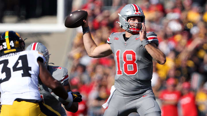 Oct 5, 2024; Columbus, Ohio, USA; Ohio State Buckeyes quarterback Will Howard (18) drops to throw against the Iowa Hawkeyes during the first quarter at Ohio Stadium.