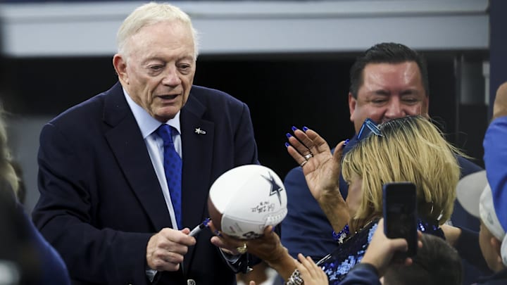 Dallas Cowboys owner Jerry Jones signs autographs before the game against the Washington Commanders