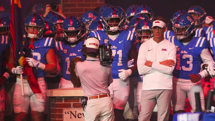 Nov 15, 2025; Oxford, Mississippi, USA; Mississippi Rebels head coach Lane Kiffin stands with his players before a game against the Florida Gators at Vaught-Hemingway Stadium. Mandatory Credit: Petre Thomas-Imagn Images