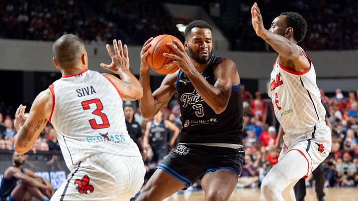 La Familia's Andrew Harrison (5) makes his way around The Ville's Russ Smith (6) and Peyton Siva (3)during their game on Monday, July 29, 2024 at Freedom Hall in Louisville, Ky. during the quarter finals of The Basketball Tournament. La Familia's Andrew Harrison (5) makes his way around The Ville's Russ Smith (6) and Peyton Siva (3)during their game on Monday, July 29, 2024 at Freedom Hall in Louisville, Ky. during the quarter finals of The Basketball Tournament.