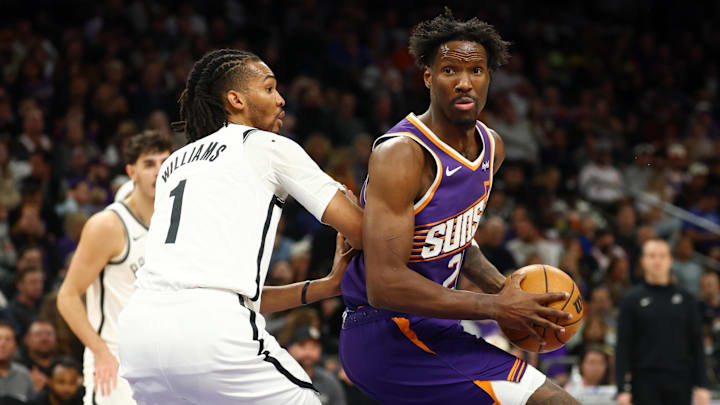 Jan 27, 2026; Phoenix, Arizona, USA; Phoenix Suns forward Nigel Hayes-Davis (21) drives to the basket against Brooklyn Nets forward Ziaire Williams (1) in the first half at Mortgage Matchup Center. Mandatory Credit: Mark J. Rebilas-Imagn Images