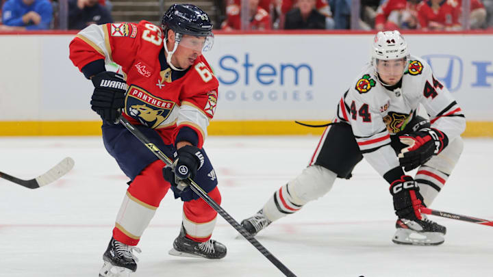 Oct 7, 2025; Sunrise, Florida, USA; Florida Panthers left wing Brad Marchand (63) moves the puck against Chicago Blackhawks defenseman Wyatt Kaiser (44) during the first period at Amerant Bank Arena. Mandatory Credit: Sam Navarro-Imagn Images Oct 7, 2025; Sunrise, Florida, USA; Florida Panthers left wing Brad Marchand (63) moves the puck against Chicago Blackhawks defenseman Wyatt Kaiser (44) during the first period at Amerant Bank Arena. Mandatory Credit: Sam Navarro-Imagn Images