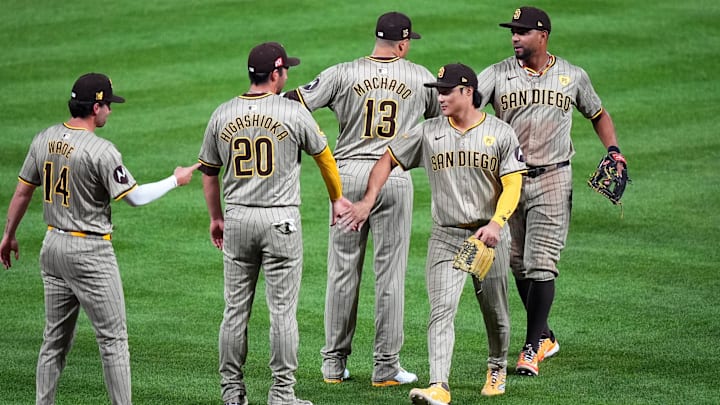 Aug 17, 2024; Denver, Colorado, USA; San Diego Padres third base Tyler Wade (14) and catcher Kyle Higashioka (20) and third base Manny Machado (13) and second base Xander Bogaerts (2) and shortstop Ha-Seong Kim (7) celebrate defeating the Colorado Rockies at Coors Field. Mandatory Credit: Ron Chenoy-Imagn Images Aug 17, 2024; Denver, Colorado, USA; San Diego Padres third base Tyler Wade (14) and catcher Kyle Higashioka (20) and third base Manny Machado (13) and second base Xander Bogaerts (2) and shortstop Ha-Seong Kim (7) celebrate defeating the Colorado Rockies at Coors Field. Mandatory Credit: Ron Chenoy-Imagn Images