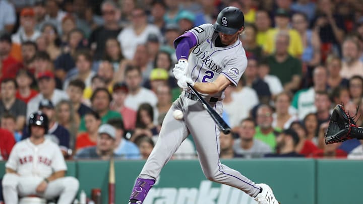 Jul 7, 2025; Boston, Massachusetts, USA; Colorado Rockies third baseman Ryan McMahon (24) hits an RBI single during the fifth inning against the Boston Red Sox at Fenway Park. Mandatory Credit: Paul Rutherford-Imagn Images