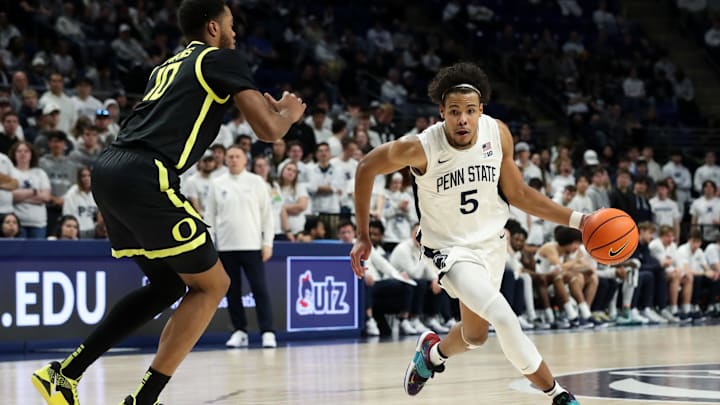 Penn State Nittany Lions forward Puff Johnson dribbles the ball toward the basket as Oregon Ducks forward Kwame Evans Jr. defends during the first half at Bryce Jordan Center. 