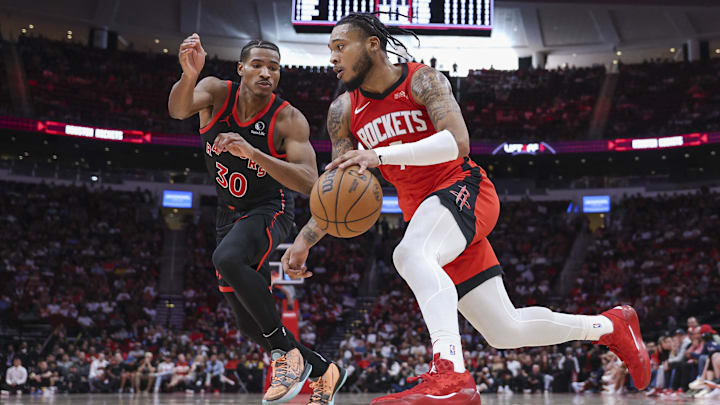Feb 9, 2025; Houston, Texas, USA; Houston Rockets forward Cam Whitmore (7) drives with the ball as Toronto Raptors guard Ochai Agbaji (30) defends during the fourth quarter at Toyota Center. Mandatory Credit: Troy Taormina-Imagn Images