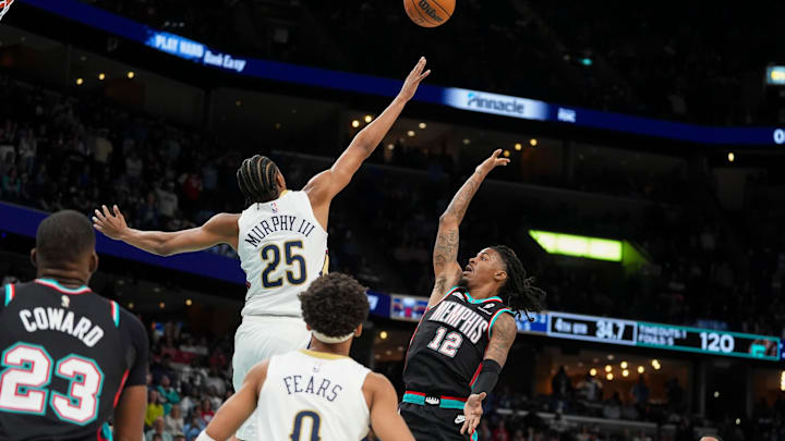 Grizzlies' Ja Morant (12) shoots the ball as Pelicans' Trey Murphy III (25) guards him during the home opener against the New Orleans Pelicans at FedExForum on October 22, 2025.