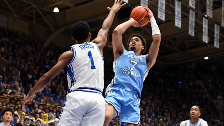 Mar 7, 2026; Durham, North Carolina, USA; North Carolina Tar Heels guard Seth Trimble (7) shoots over Duke Blue Devils guard Caleb Foster (1) during the first half at Cameron Indoor Stadium. Mandatory Credit: Rob Kinnan-Imagn Images
