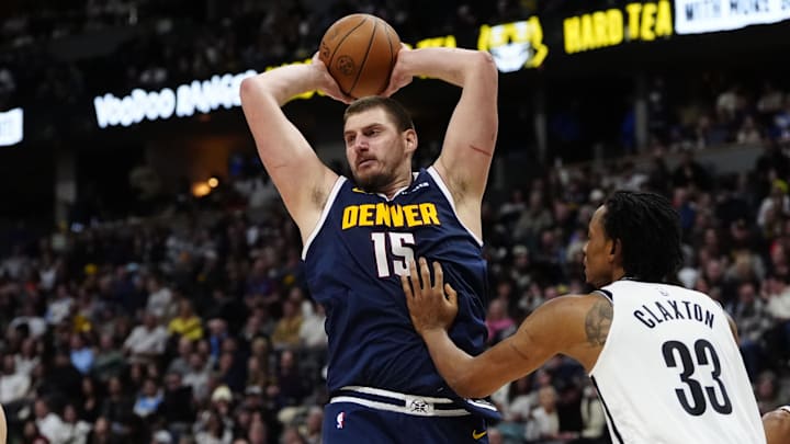 Jan 10, 2025; Denver, Colorado, USA; Brooklyn Nets center Nic Claxton (33) defends on Denver Nuggets center Nikola Jokic (15) in the second half at Ball Arena.