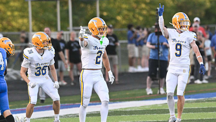 Olentangy's Brody Maslouski (left), Kaden Gebhardt and Zayden Brigner celebrate a Braves’ on-side kick recovery Aug. 22, 2025, at Olentangy Liberty. (photo by John Hulkenberg)