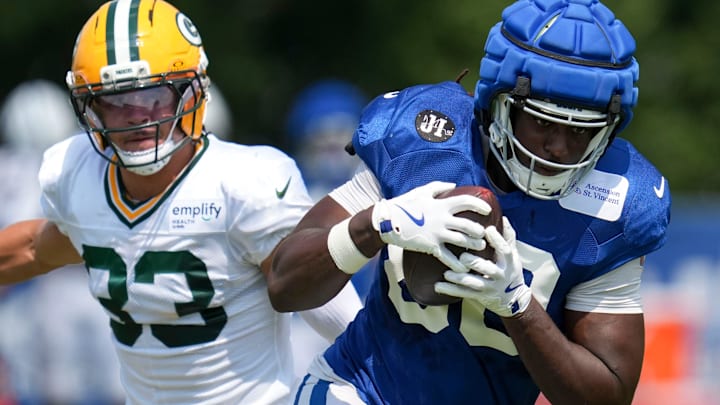 Green Bay Packers safety Evan Williams (33) attempts to take down Indianapolis Colts tight end Jelani Woods (80) on Thursday, Aug. 14, 2025, at a joint practice during Indianapolis Colts’ training camp at Grand Park in Westfield.