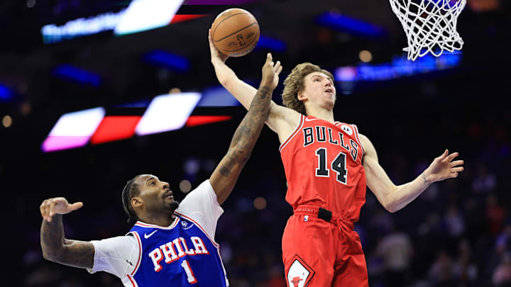 Feb 24, 2025; Philadelphia, Pennsylvania, USA; Chicago Bulls forward Matas Buzelis (14) drives and misses a dunk in front of Philadelphia 76ers center Andre Drummond (1) during the fourth quarter at Wells Fargo Center. Mandatory Credit: Bill Streicher-Imagn Images