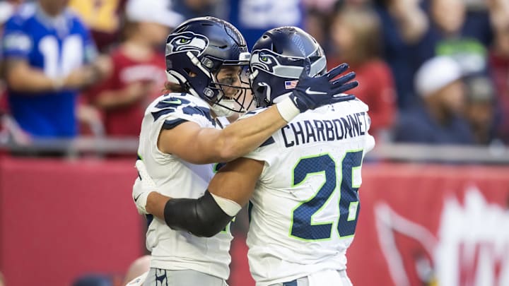 Dec 8, 2024; Glendale, Arizona, USA; Seattle Seahawks running back Zach Charbonnet (26) celebrates a touchdown with teammate Jake Bobo against the Arizona Cardinals in the first half at State Farm Stadium. Mandatory Credit: Mark J. Rebilas-Imagn Images