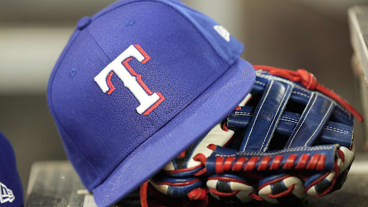 A hat and glove of a Texas Rangers player.