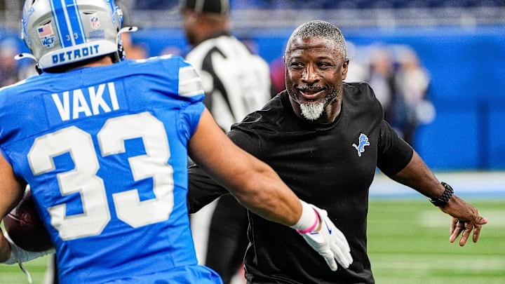 Detroit Lions defensive coordinator Aaron Glenn shakes hands with running back Sione Vaki (33) during warm up before the Tennessee Titans game at Ford Field in Detroit on Sunday, Oct. 27, 2024. Detroit Lions defensive coordinator Aaron Glenn shakes hands with running back Sione Vaki (33) during warm up before the Tennessee Titans game at Ford Field in Detroit on Sunday, Oct. 27, 2024.