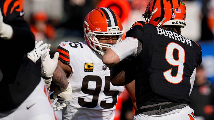 Cincinnati Bengals quarterback Joe Burrow (9) is pursued by Cleveland Browns defensive end Myles Garrett (95) in the first quarter of the NFL Week 18 game between the Cincinnati Bengals and the Cleveland Browns at Paycor Stadium in Downtown Cincinnati on Sunday, Jan. 4, 2026.