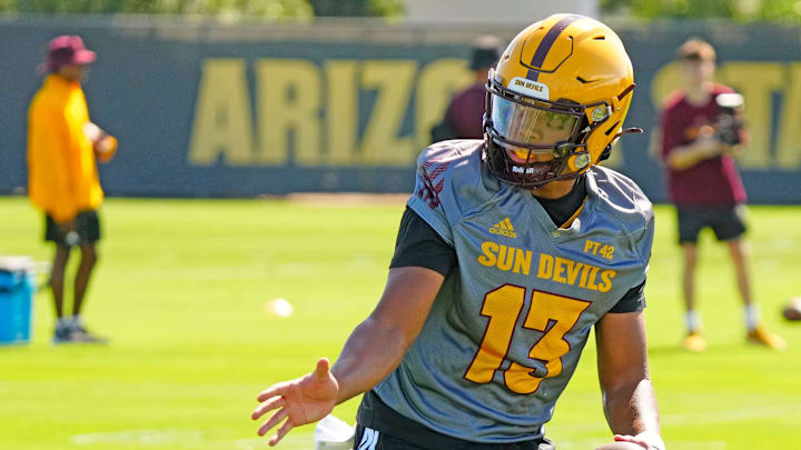 Arizona State quarterback Cameron Dyer (13) fakes a hand-off during the first day of fall practice in Tempe, Ariz. on July 30, 2025. Arizona State quarterback Cameron Dyer (13) fakes a hand-off during the first day of fall practice in Tempe, Ariz. on July 30, 2025.