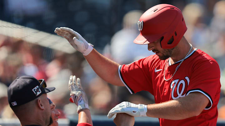 Mar 2, 2025; West Palm Beach, Florida, USA; Washington Nationals third baseman Paul DeJong (14) celebrates with teammates after hitting a two-run home run against the Houston Astros during the third inning at CACTI Park of the Palm Beaches. 