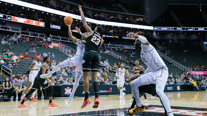 Mar 12, 2024; Kansas City, MO, USA; UCF Knights guard Shemarri Allen (2) shoots the ball around Brandon Garrison (23).