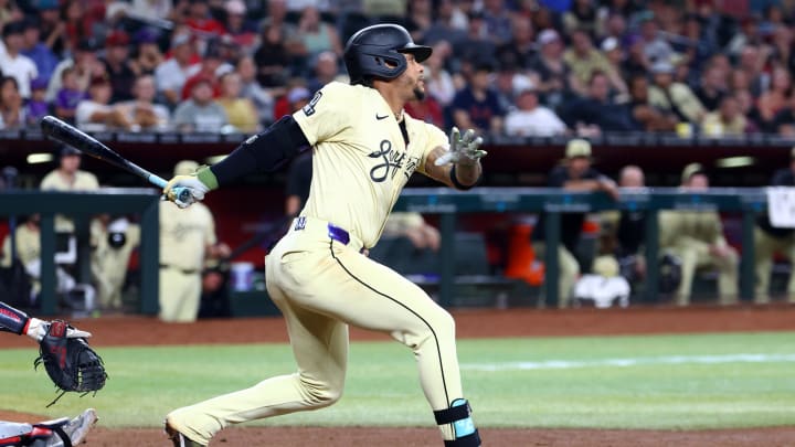 Jun 25, 2024; Phoenix, Arizona, USA; Arizona Diamondbacks infielder Ketel Marte hits an RBI single in the seventh inning against the Minnesota Twins at Chase Field. Mandatory Credit: Mark J. Rebilas-USA TODAY Sports