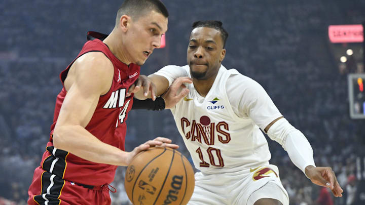 Apr 20, 2025; Cleveland, Ohio, USA; Miami Heat guard Tyler Herro (14) drives against Cleveland Cavaliers guard Darius Garland (10) in the first quarter at Rocket Arena. Mandatory Credit: David Richard-Imagn Images
