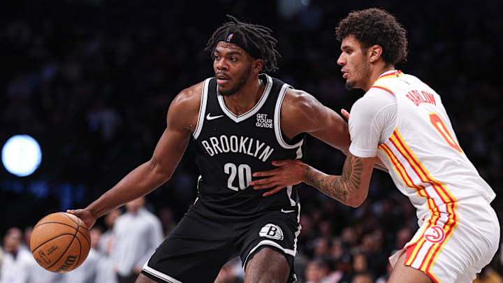 Mar 16, 2025; Brooklyn, New York, USA; Brooklyn Nets center Day'Ron Sharpe (20) is defended by Atlanta Hawks forward Dominick Barlow (0) during the second half at Barclays Center. Mandatory Credit: Vincent Carchietta-Imagn Images