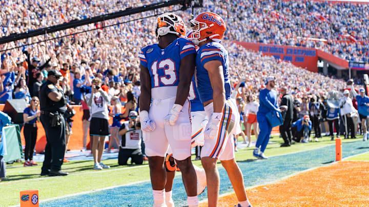 Nov 23, 2024; Gainesville, Florida, USA; Florida Gators running back Jadan Baugh (13) celebrates scoring a touchdown with Florida Gators wide receiver Chimere Dike (17) against the Mississippi Rebels during the first half at Ben Hill Griffin Stadium. Mandatory Credit: Matt Pendleton-Imagn Images