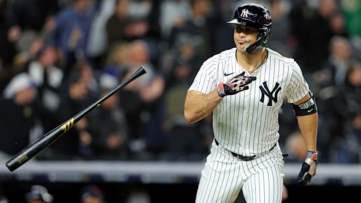 Oct 14, 2024; Bronx, New York, USA; New York Yankees designated hitter Giancarlo Stanton (27) hits a solo home run during the seventh inning against the Cleveland Guardians in game one of the ALCS for the 2024 MLB Playoffs at Yankee Stadium. Mandatory Credit: Brad Penner-Imagn Images