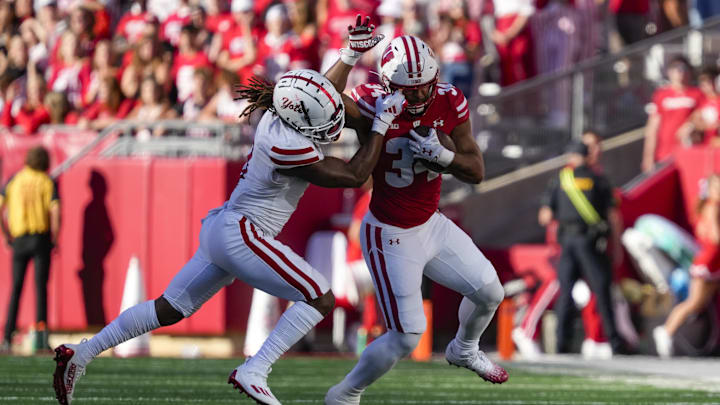 Sep 7, 2024; Madison, Wisconsin, USA;  South Dakota Coyotes defensive back Teven McKelvey (3) grabs the facemask of Wisconsin Badgers running back Jackson Acker (34)  during the fourth quarter at Camp Randall Stadium. 