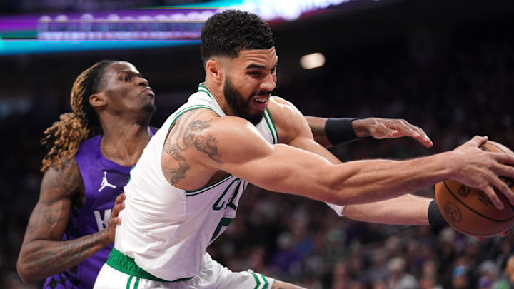 Mar 24, 2025; Sacramento, California, USA: Boston Celtics forward Jayson Tatum (0) holds onto a rebound in front of Sacramento Kings guard Keon Ellis (23) in the third quarter at the Golden 1 Center. Mandatory Credit: Cary Edmondson-Imagn Images