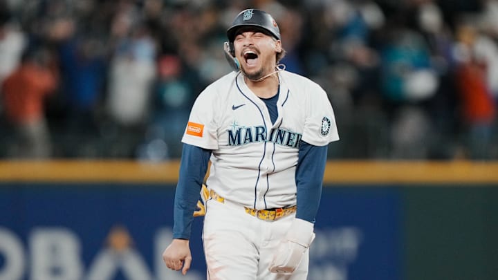 Oct 17, 2025; Seattle, Washington, USA; Seattle Mariners first baseman Josh Naylor (12) reacts after third baseman Eugenio Suarez (not pictured) hits a grand slam against the Toronto Blue Jays in the eighth inning during game five of the ALCS round for the 2025 MLB playoffs at T-Mobile Park. Mandatory Credit: Stephen Brashear-Imagn Images Oct 17, 2025; Seattle, Washington, USA; Seattle Mariners first baseman Josh Naylor (12) reacts after third baseman Eugenio Suarez (not pictured) hits a grand slam against the Toronto Blue Jays in the eighth inning during game five of the ALCS round for the 2025 MLB playoffs at T-Mobile Park. Mandatory Credit: Stephen Brashear-Imagn Images