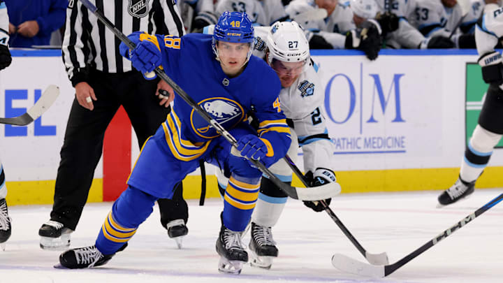 Dec 7, 2024; Buffalo, New York, USA;  Buffalo Sabres center Tyson Kozak (48) wins a face-off against Utah Hockey Club center Barrett Hayton (27) during the first period at KeyBank Center. Mandatory Credit: Timothy T. Ludwig-Imagn Images