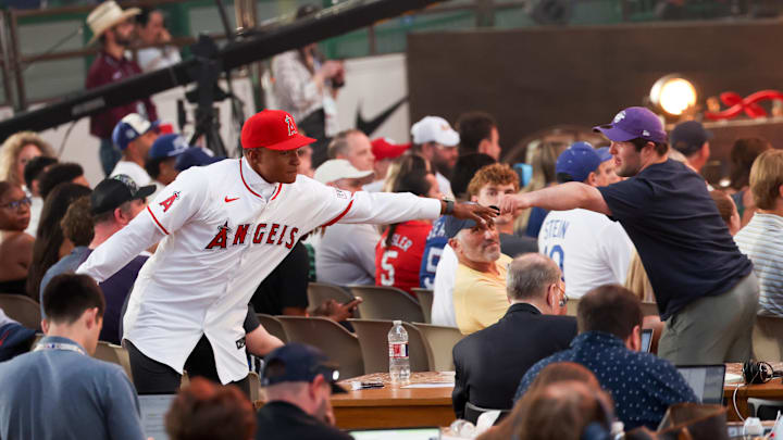 Jul 14, 2024; Ft. Worth, TX, USA;  Christian Moore celebrates with fans after being selected by the Los Angeles Angels as the eight player taken during the first round of the MLB Draft at Cowtown Coliseum. Mandatory Credit: Kevin Jairaj-Imagn Images