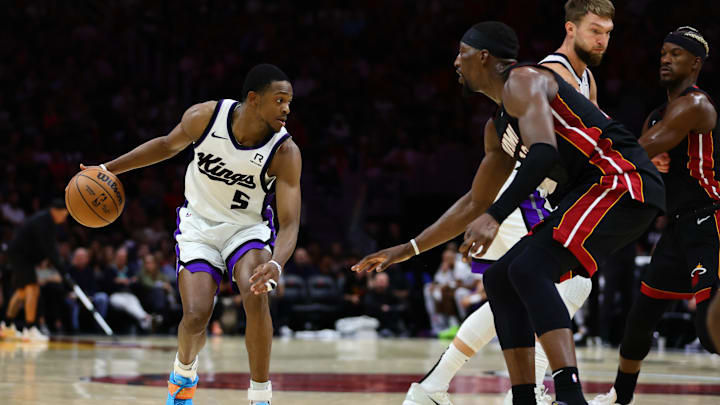 Nov 4, 2024; Miami, Florida, USA; Sacramento Kings guard De'Aaron Fox (5) dribbles the basketball against Miami Heat center Bam Adebayo (13) during the third quarter at Kaseya Center. Mandatory Credit: Sam Navarro-Imagn Images