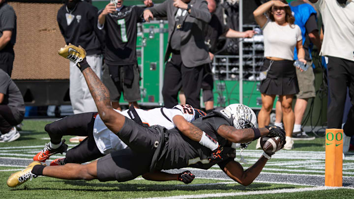 Oregon Ducks wide receiver Dakorien Moore dives in for a touchdown under coverage from Oregon State Beavers defensive back Jalil Tucker as the Oregon Ducks host the Oregon State Beavers Sept. 20, 2025, at Autzen Stadium in Eugene, Oregon.