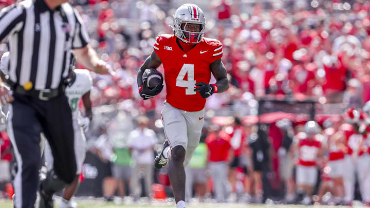 Sep 21, 2024; Columbus, Ohio, USA;  Ohio State Buckeyes wide receiver Jeremiah Smith (4) breaks away for a touchdown during the third quarter against the Marshall Thundering Herd at Ohio Stadium. Mandatory Credit: Joseph Maiorana-Imagn Images