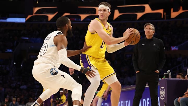 Los Angeles Lakers guard Austin Reaves looks to pass against Minnesota Timberwolves guard Mike Conley during the second quarter at Crypto.com Arena in Los Angeles on Feb. 27, 2025.