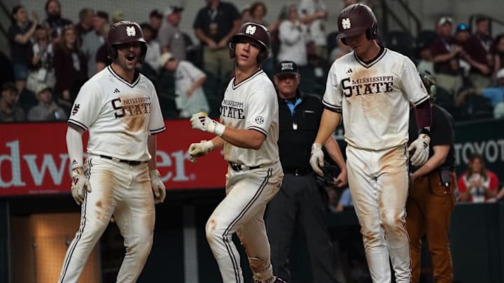 The Mississippi State Bulldogs celebrate at home plate after scoring against the UCLA Bruins.