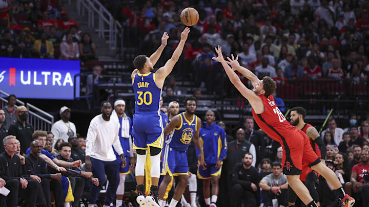 Oct 29, 2023; Houston, Texas, USA; Golden State Warriors guard Stephen Curry (30) shoots the ball as Houston Rockets center Alperen Sengun (28) defends during the fourth quarter at Toyota Center. Mandatory Credit: Troy Taormina-Imagn Images