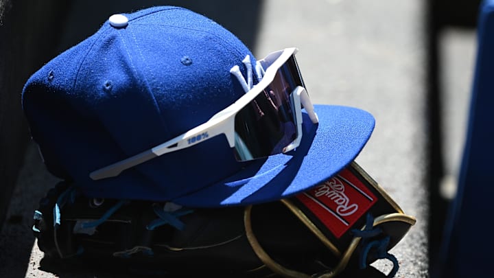 May 9, 2022; Baltimore, Maryland, USA; A detailed view of Kansas City Royals hat and glove in the dugout during the first inning against the Baltimore Orioles at Oriole Park at Camden Yards. May 9, 2022; Baltimore, Maryland, USA; A detailed view of Kansas City Royals hat and glove in the dugout during the first inning against the Baltimore Orioles at Oriole Park at Camden Yards.