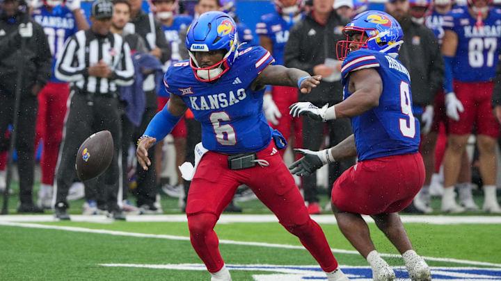 Oct 25, 2025; Lawrence, Kansas, USA; Kansas Jayhawks quarterback Jalon Daniels (6) looses the ball from a bad snap against the Kansas State Wildcats during the second half of the game at David Booth Kansas Memorial Stadium. Mandatory Credit: Denny Medley-Imagn Images