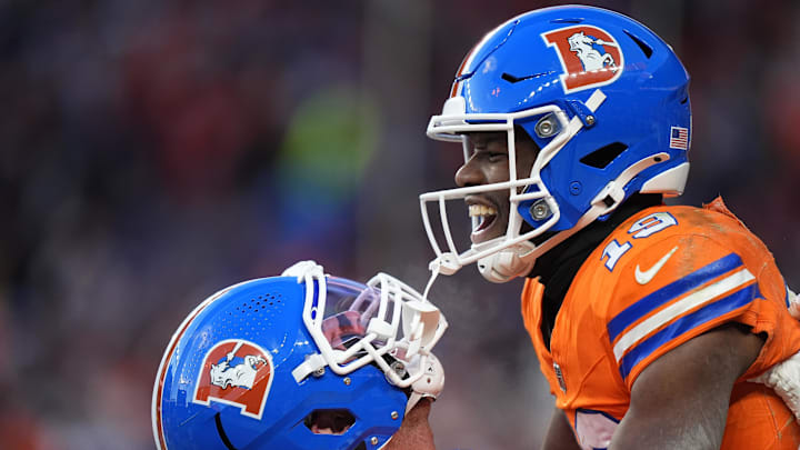 Jan 5, 2025; Denver, Colorado, USA; Denver Broncos wide receiver Marvin Mims Jr. (19) celebrates his touchdown withtight end Lucas Krull (85) in the second half against the Kansas City Chiefs at Empower Field at Mile High. 