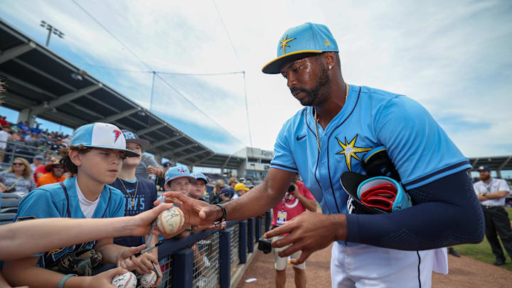 Port Charlotte, Florida, USA; Tampa Bay Rays designated hitter Eloy Jimenez (74) signs autographs before a game against the New York Mets during spring training at Charlotte Sports Park.