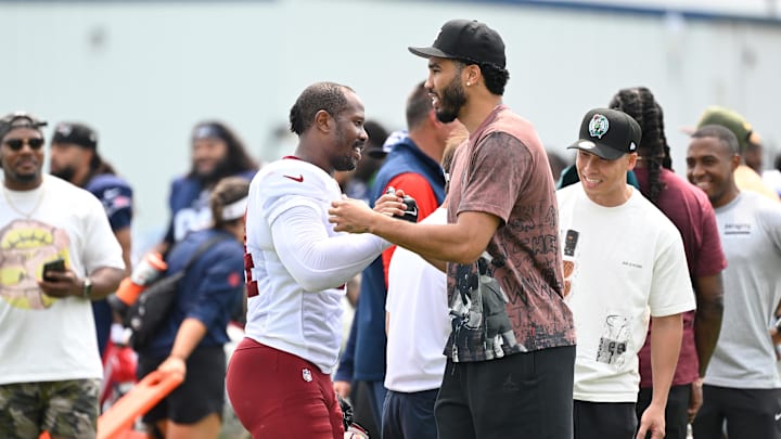 Aug 6, 2025; Foxborough, MA, USA; Boston Celtics Jayson Tatum (black hat) forward embraces Washington Commanders linebacker Von Miller (24) at training camp at Gillette Stadium. Mandatory Credit: Eric Canha-Imagn Images