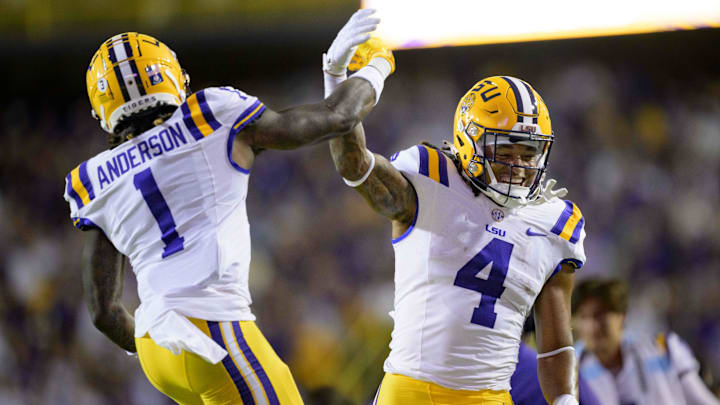 Oct 14, 2023; Baton Rouge, Louisiana, USA; LSU Tigers running back John Emery Jr. (4) celebrates his touchdown with wide receiver Aaron Anderson (1) against the Auburn Tigers during the first quarter during the first quarter at Tiger Stadium. Mandatory Credit: Matthew Hinton-Imagn Images
